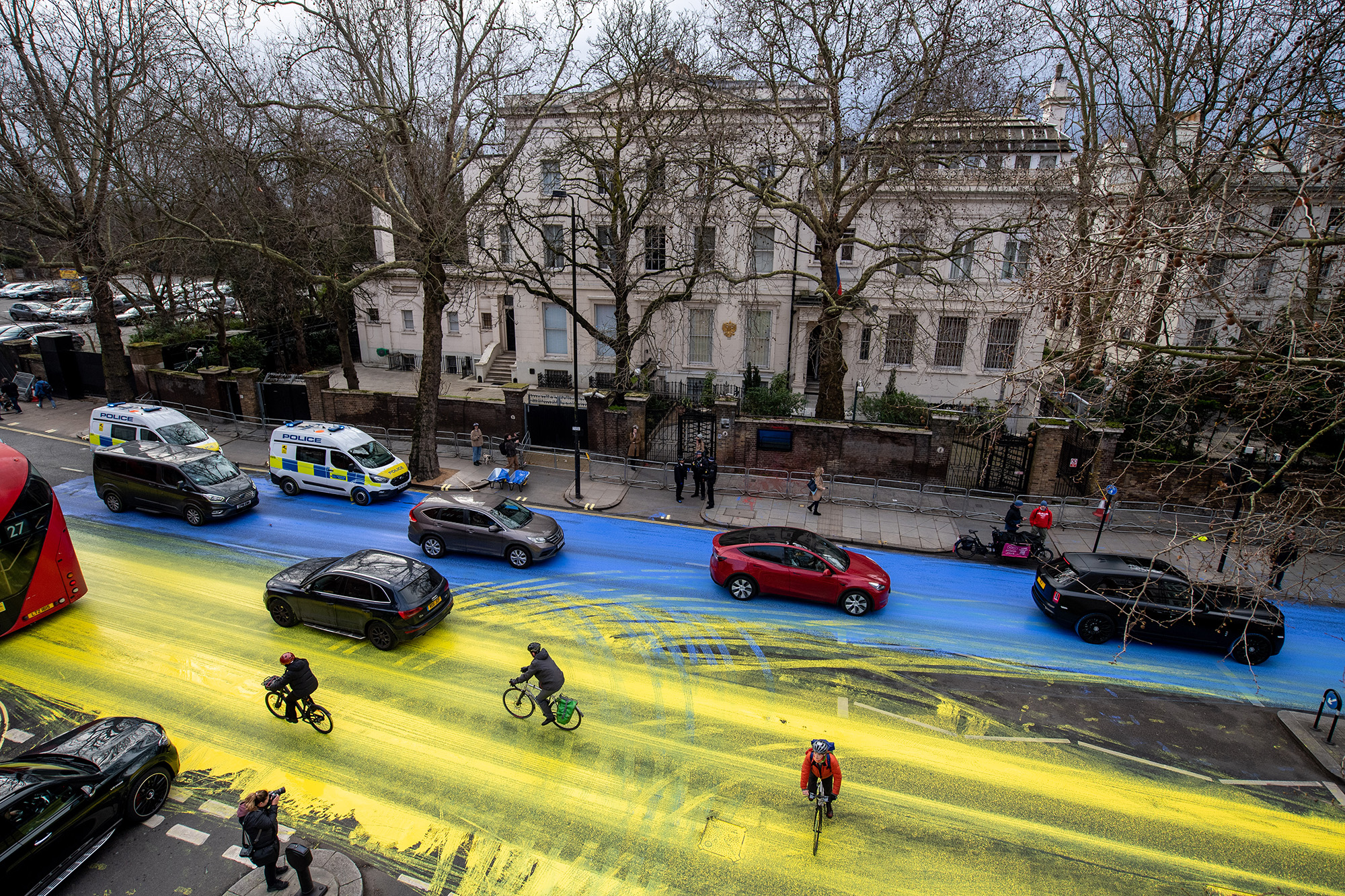 Protest group creates giant Ukraine flag on road outside Russian embassy